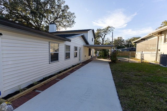 view of side of property with a yard and a carport