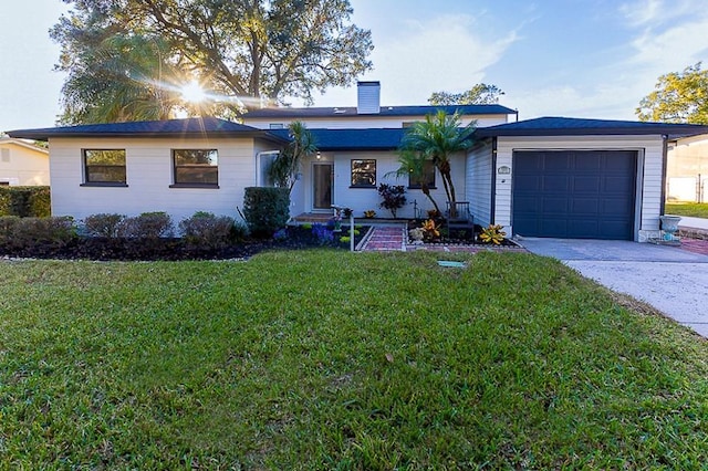 ranch-style home with a front lawn and a garage