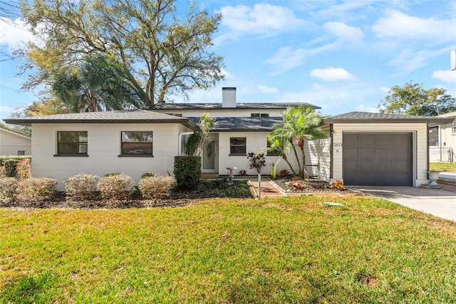 view of front of house with a garage and a front yard