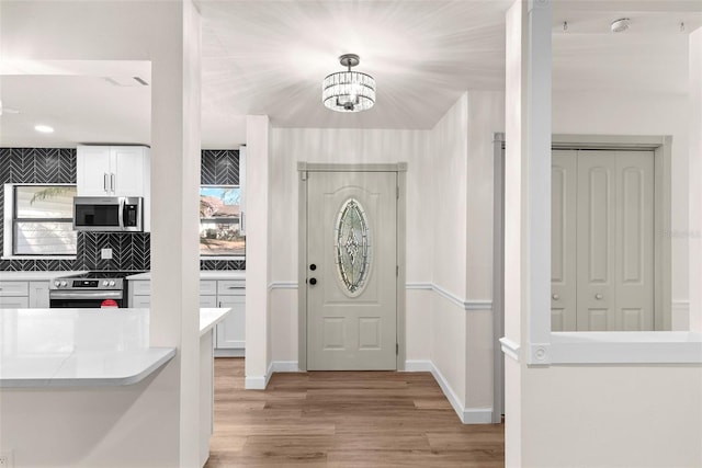 entrance foyer with light hardwood / wood-style flooring