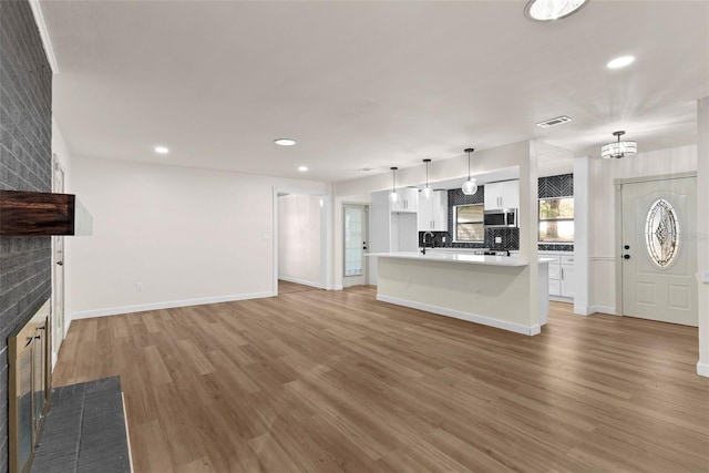 unfurnished living room featuring hardwood / wood-style flooring and a fireplace