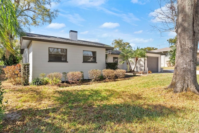 ranch-style home featuring a garage and a front yard