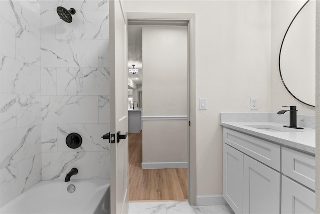 bathroom with tiled shower / bath and vanity