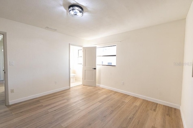 spare room with light wood-type flooring