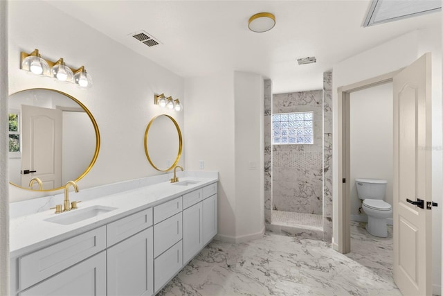 bathroom featuring vanity, toilet, and tiled shower