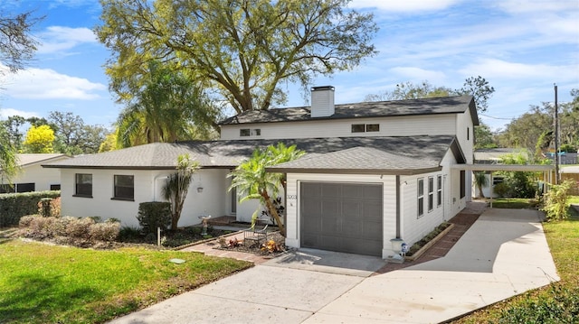 view of front of home with a garage and a front lawn