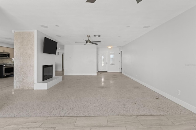 unfurnished living room with ceiling fan