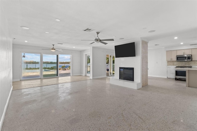 unfurnished living room featuring ceiling fan and a fireplace