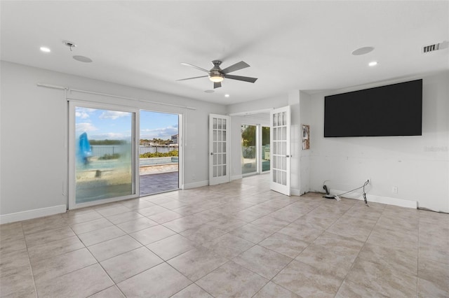 unfurnished living room featuring ceiling fan, light tile patterned flooring, and french doors