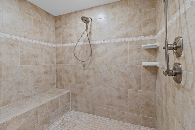 bathroom with a tile shower