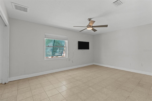 unfurnished room with a textured ceiling and ceiling fan