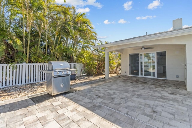 view of patio with ceiling fan and a grill