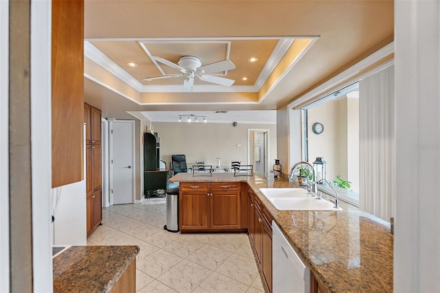 kitchen featuring white dishwasher, a raised ceiling, sink, ornamental molding, and kitchen peninsula