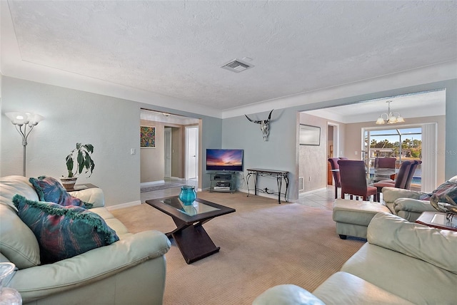 living room featuring a notable chandelier, light colored carpet, and a textured ceiling