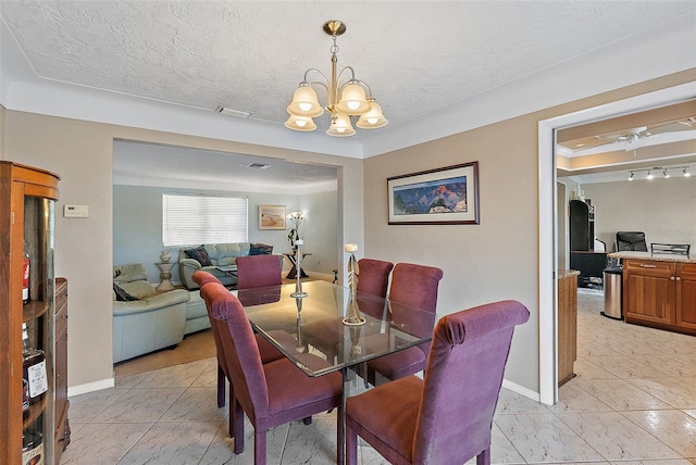 dining room with ceiling fan with notable chandelier and a textured ceiling