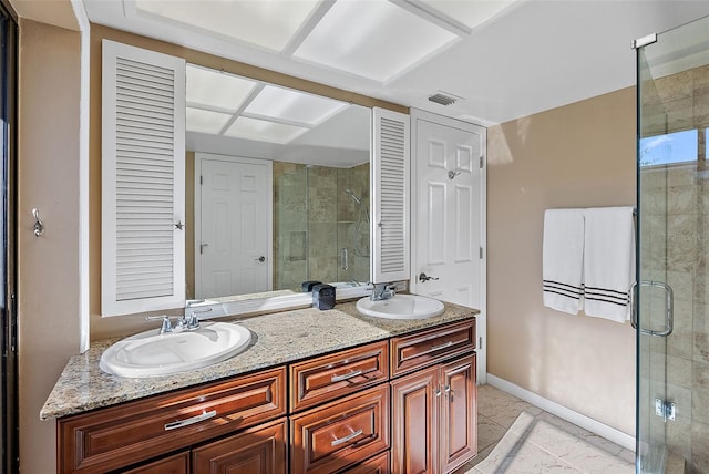 bathroom with tile patterned flooring, vanity, and a shower with shower door