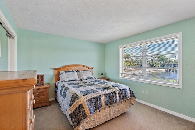 carpeted bedroom featuring a textured ceiling