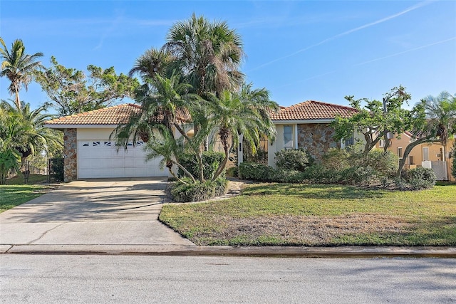 mediterranean / spanish home with a garage and a front yard