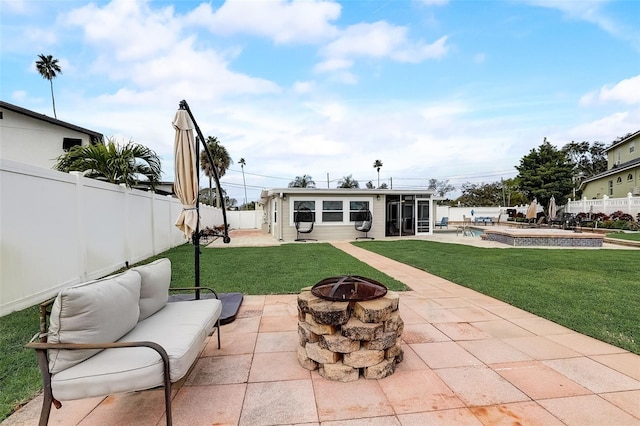 view of patio featuring a swimming pool, a fire pit, and a sunroom