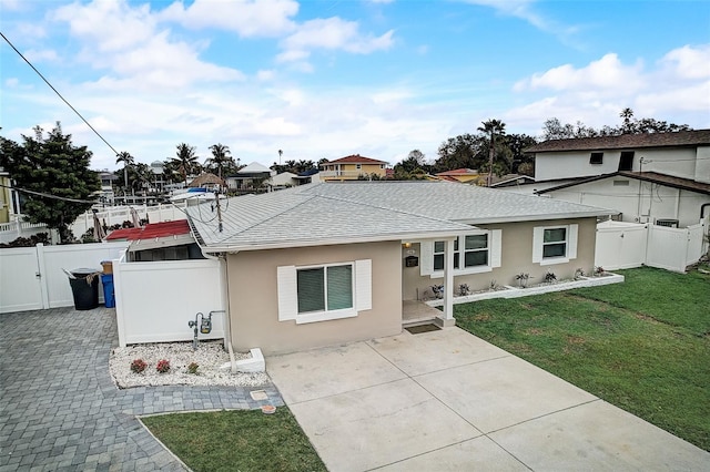 ranch-style house with a patio and a front lawn