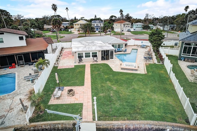 view of pool with a patio area, a sunroom, and a yard