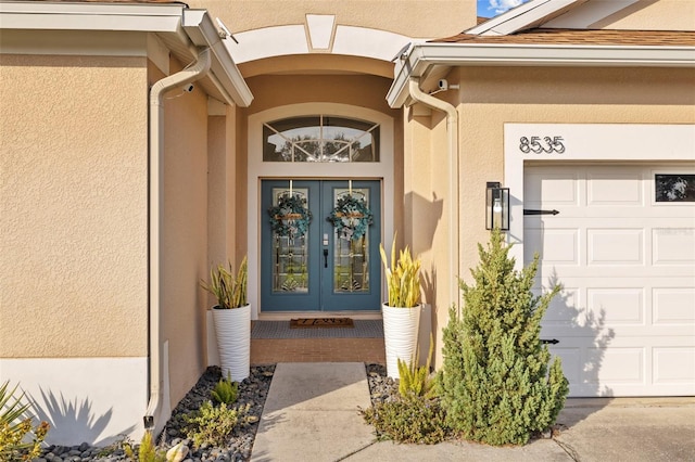 doorway to property with french doors and a garage