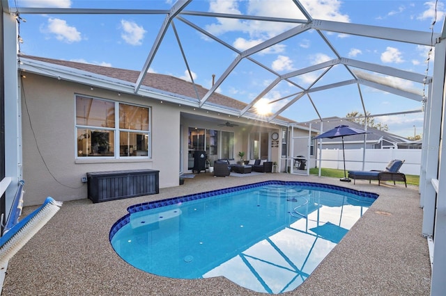 view of pool featuring a patio area, ceiling fan, and a lanai