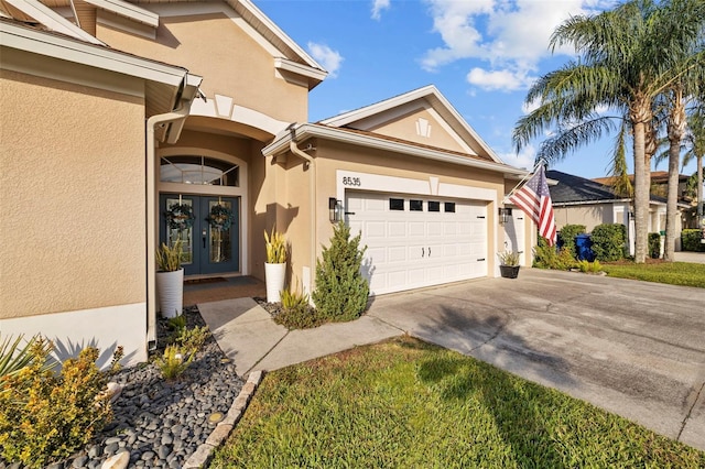 exterior space with a garage and french doors