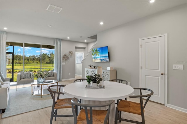 dining area with light hardwood / wood-style flooring