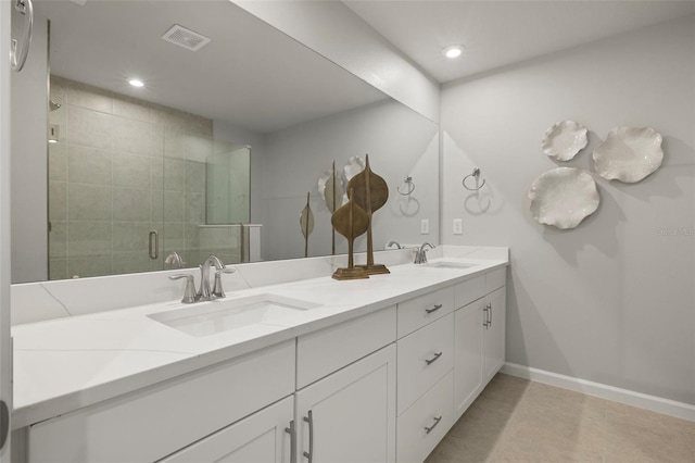 bathroom featuring tile patterned floors, vanity, and a shower with door