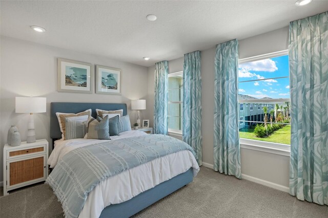 bedroom featuring carpet and a textured ceiling