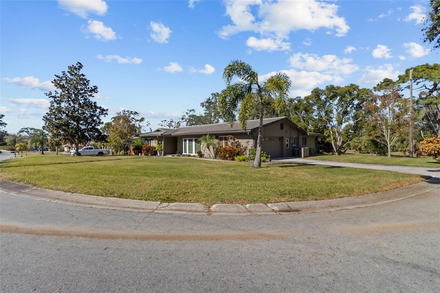 single story home featuring a garage and a front lawn