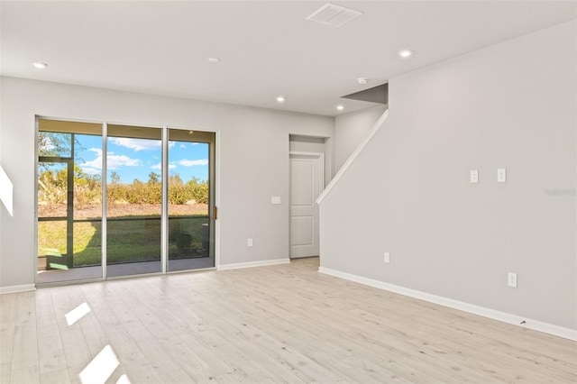 spare room featuring light hardwood / wood-style floors