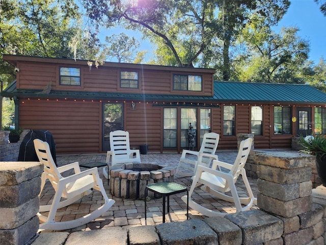 back of house featuring a patio area and an outdoor fire pit