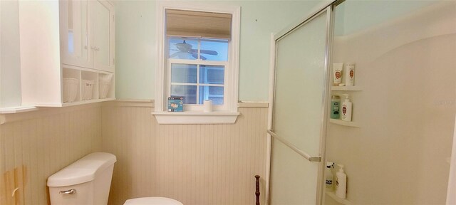 2800 47th St S, Gulfport, FL 33711 - bathroom with wainscoting, toilet, and a shower with shower door