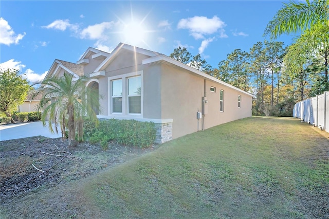 view of side of property featuring a yard