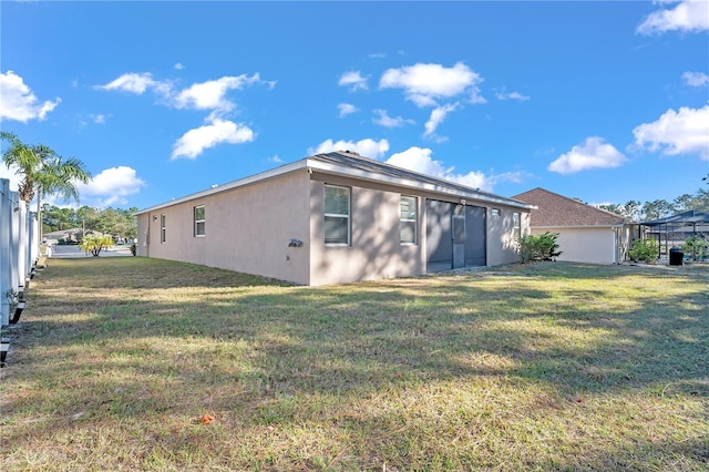 rear view of property with a yard