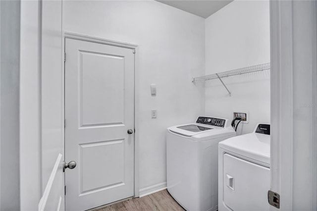 washroom featuring washer and dryer and light wood-type flooring