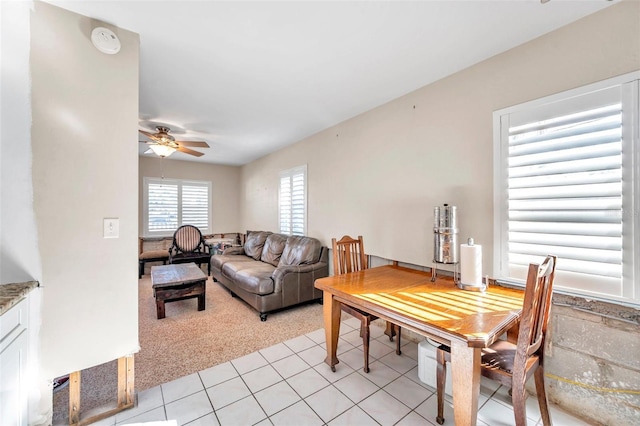 carpeted living room with ceiling fan