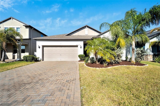 view of front of house with a front lawn and a garage