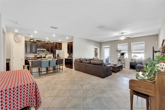 living room with ceiling fan and light tile patterned floors