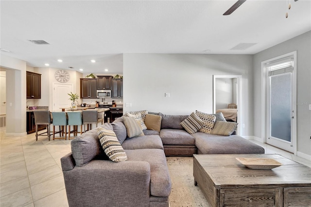 tiled living room with ceiling fan