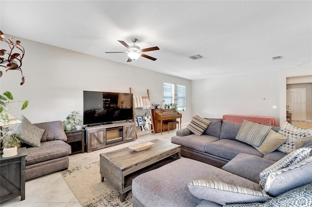 living room featuring ceiling fan and light tile patterned flooring