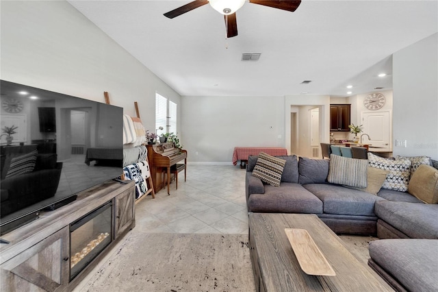 tiled living room featuring ceiling fan