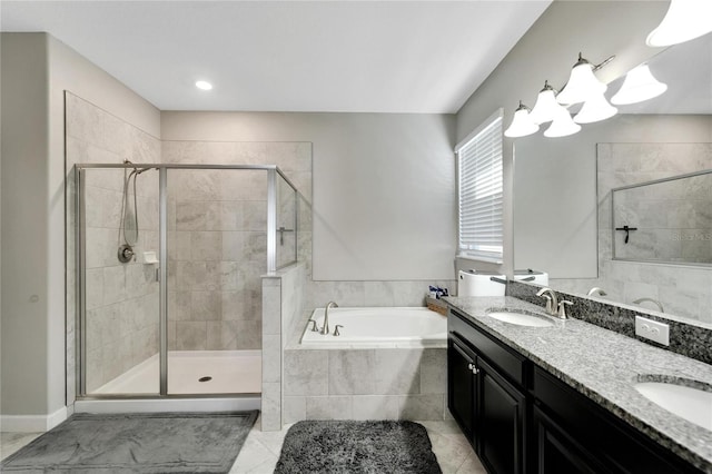 bathroom featuring tile patterned flooring, vanity, and shower with separate bathtub