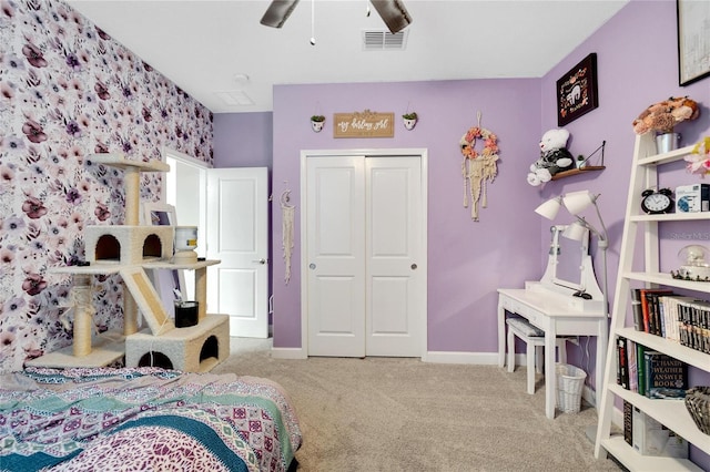 bedroom featuring ceiling fan, a closet, and light colored carpet