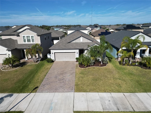 view of front of home featuring a front lawn and a garage