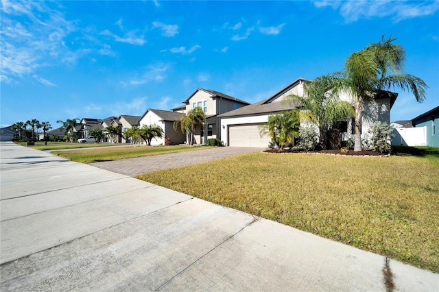 view of front of property with a garage and a front yard