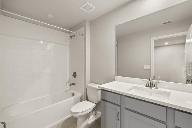 full bathroom with vanity, tile patterned flooring, tiled shower / bath combo, and toilet