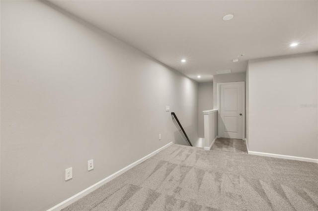 spare room featuring light colored carpet